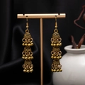 Macro shot of vintage gold Jhumka earrings with triple-layered bells and carved floral detail - H4184-1 Antique Gold