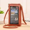Detail showing coral pink phone crossbody bag with TPU touch screen window for easy operation - Brown