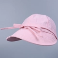 Close-up of pink nylon sun hat with decorative ribbon bow and wide brim for UV protection - M (56-58cm) / Pink
