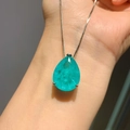 Elegant pear-cut blue-green gemstone pendant with silver-tone chain on arm - Paraiba Blue Pear Pendant Only (Without Earrings)