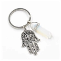 Macro view of Hamsa Hand charm with a polished white crystal hexagonal pillar keychain - Opalite