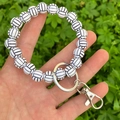 Detail of volleyball-themed beaded wristlet keychain with black and white sport beads - White Volleyball