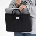 Detailed view of black quilted laptop bag with sturdy handles and woven label - Horizontal 13.3-14 Inch Laptop Bag / Black