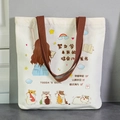 White canvas tote bag with brown handles and cute cartoon hamster illustration - Study Hard