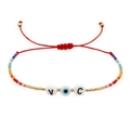 Bracciale dell'amicizia intrecciato a mano con cordino rosso, perline e occhio greco - Malocchio Con Lettere VC