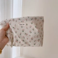 Detail of floral cotton linen makeup bag with simple wish logo held by hand - Light Pink Floral Cosmetic Bag