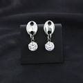 Close-up of silver pig-nose stud earrings with sparkling round cubic zirconia drops - Stud Earrings / Silver