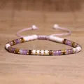 Adjustable woven bracelet with purple amethyst and tiger eye beads on wood background - 100 Amethyst Flower