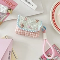 Close-up of quilted pink plaid and blue animal print storage pouch with heart buckle - Salt Style Bunny