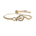 Detail of adjustable gold bracelet with infinity symbols, stars, and sparkling zircon - Infinity Gold + Bead Box Chain