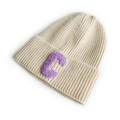 Chic off-white knit beanie hat featuring a purple velvet letter C patch on the folded brim - Beige