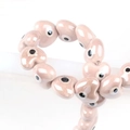 Pink heart-shaped ceramic evil eye beads for handmade jewelry making and DIY crafts - 13x14mm / Dusky Pink