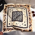 Detail of silk scarf showing zebra and leopard prints with fine rolled edge craftsmanship - 65*65cm / Caramel Brown