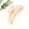 Detail view of handmade golden metal hair claw with inlaid natural clear crystal stones - Gold + Clear Quartz
