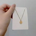 Close-up of golden titanium steel heart-shaped lock pendant necklace on card - DN114 Heart Lock