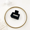 Macro shot of matte black square hollow hair claw clip on minimalist white aesthetic background - Black