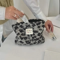 Close-up of leopard print plush cosmetic bag with hand placing cream inside the bag - Grey Leopard