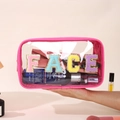Close-up of waterproof PVC toiletry bag with colorful FACE chenille letter patches - Rose Red (FACE)