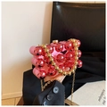 Detail of bright pink spherical clutch bag with golden bead handle and metallic finish - Pink