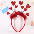 Valentine's Day headband with red sequin hearts and feather trim on a white display stand - 9 Hearts Design