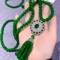 Long beaded sweater necklace in green with an ornate silver hollow pendant and tassel - Green Ceramic