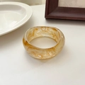 Wide irregular resin bangle with amber and cream marble texture in minimalist style - Transparent Yellow