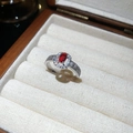 Silver finish crisscross ring with a central red stone and white zircon accents - Red Oval Main Stone Surrounding Style (50# Silver)