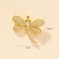 Detailed size view of a golden dragonfly pendant with sparkling white and green zircons - Style H