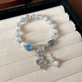 Elegant beaded bracelet featuring white cat-eye stones and a zircon-set silver snake charm - Silver-S Shape