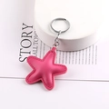 Detailed view of rose pink leather star keychain with silver ring and stitching details - Rose Red