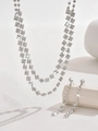 Macro shot of silver bridal necklace and long tassel earrings with sparkling crystals - 619 Silver Necklace Earrings Set