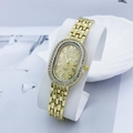 Close-up of golden oval quartz watch with rhinestone bezel and metal chain strap - Gold Gold