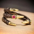 Punk style dragon claw ring in black and gold finish with a round pink gemstone inlay - Paw