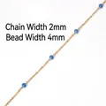 Macro view of 2mm gold chain with 4mm translucent blue beads for DIY jewelry making - Dark Blue