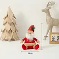 Plush Santa Claus doll in red and gold finish with snowflake details, 31cm height - Sitting Santa Claus
