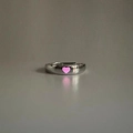 Detail of silver adjustable open ring featuring a glowing pink heart-shaped center - Adjustable Open / Heart / Pink