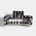 Detailed macro view of rectangular hair claw clip with black and white marble pattern texture - Black Zebra