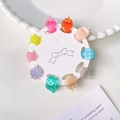 Set of 10 mini strawberry hair claws in colorful jelly tones on a round display card - Strawberry Shape 10Pcs