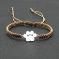 Detail view of woven brown cord bracelet with silver dog paw charm and adjustable knot - Khaki