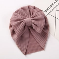 Macro shot of infant turban hat showing the high-elastic waffle knit fabric and bow - Korean Pink