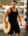 Men's solid black gym vest featuring racerback design and slim fit athletic material - Black