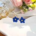 Elegant 3D blue flower earrings with gold stamens on a heart-shaped tray display - Blue