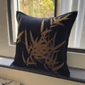 Luxury velvet throw pillow featuring golden bamboo leaf patterns on black fabric - Wide Edge Black Bamboo