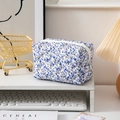 Quilted floral makeup bag in white with purple flower patterns and zipper closure - Blue Floral
