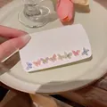 Set of eight pairs of glitter butterfly stud earrings on a display card for women - Macaron Butterfly Set