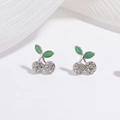Macro shot of silver cherry earrings with green enamel leaves and sparkling crystal pavé - White Gold Green Enamel White Zirconia Cherry Earrings