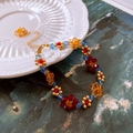 Detailed macro view of colorful beaded flower necklace with metal clasp and extension chain - Multicolor Flower Beaded Bracelet - Gold Accessories