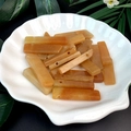 Detail of natural orange jade crystal rectangular beads in a white shell dish - Red Aventurine