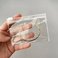 Handheld gold open cuff bracelet presented in a clear PVC jewelry storage bag - 25 Micron 10.5x7.5cm Zipper / 100 Pcs/Pack
