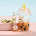 Acrylic bubble tea bear keychain with liquid sand and orange bubble charm in gold finish - Lidded Milk Tea Cup + Colorful Bead